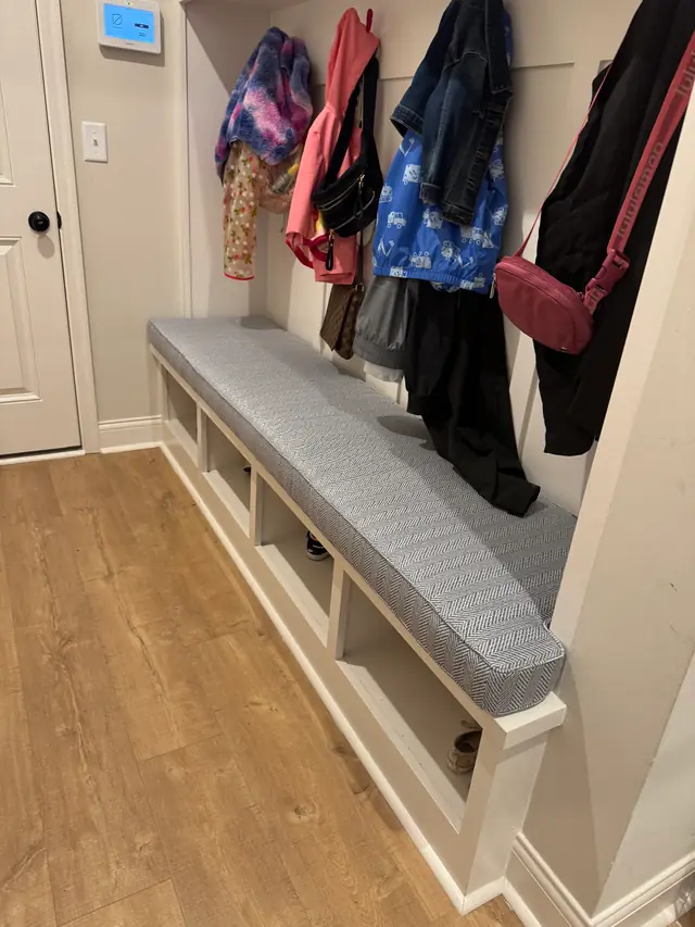 Grey fitted bench cushion in a mudroom